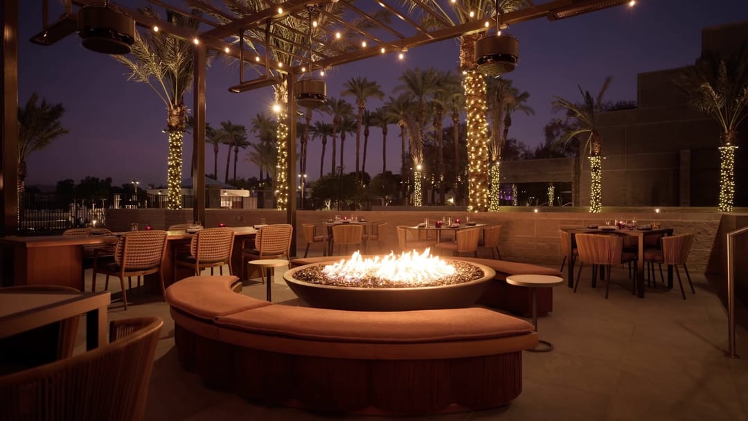Fire pit lounge under string lights at dusk, from the Grand Hyatt Scottsdale 2025 resort film
