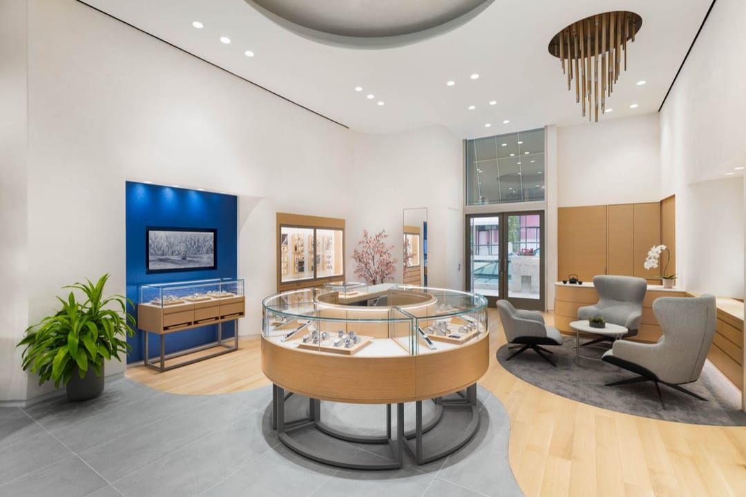 Grand Seiko boutique interior, curved watch display cases, lounge chairs and a blue wall