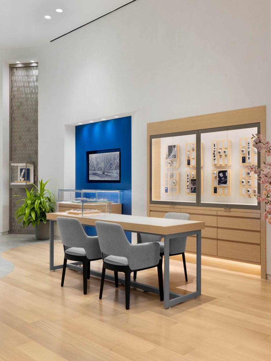 Grand Seiko consultation table and chairs beside a blue feature wall and watch displays