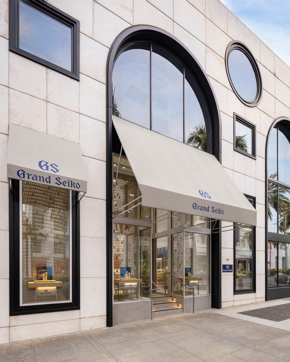 Grand Seiko boutique facade with arched and round windows, seen from an angle