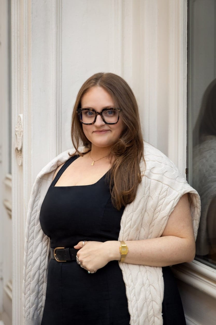 Harkov Lewis Team portrait, a woman in glasses with a cream sweater over her shoulders