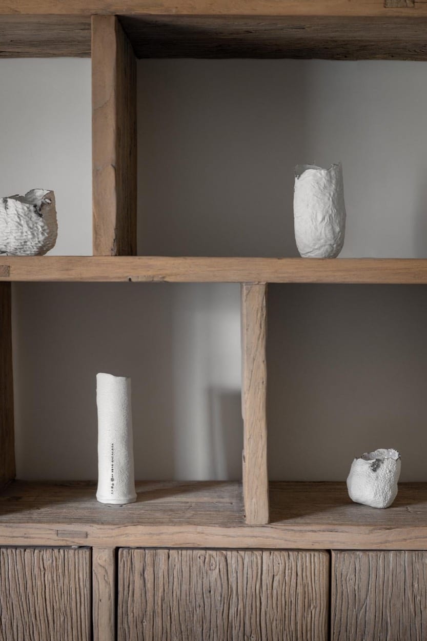 Reclaimed wood shelves with white sculptural ceramics